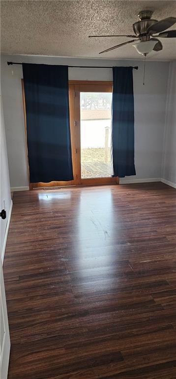 unfurnished room with ceiling fan, dark hardwood / wood-style floors, and a textured ceiling