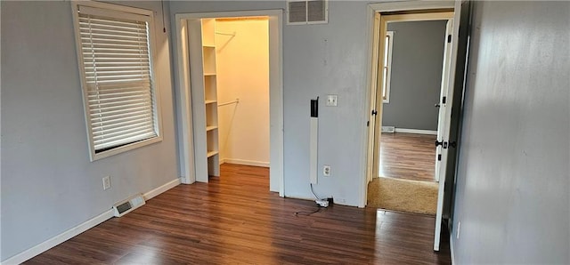 unfurnished bedroom featuring dark hardwood / wood-style floors