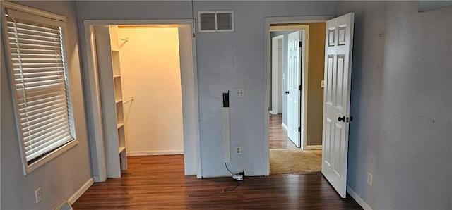 hallway with dark hardwood / wood-style flooring