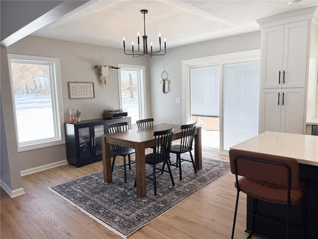 dining room featuring light hardwood / wood-style flooring and an inviting chandelier