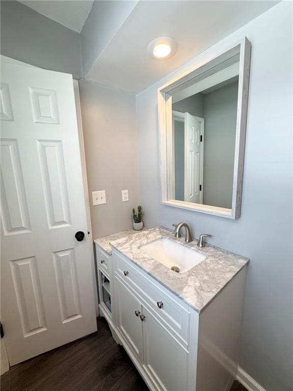 bathroom featuring hardwood / wood-style flooring and vanity