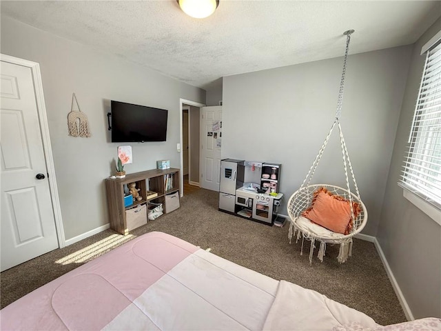 carpeted bedroom with a textured ceiling and multiple windows