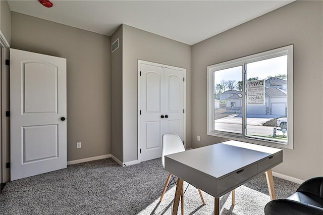 office space with baseboards, visible vents, and carpet