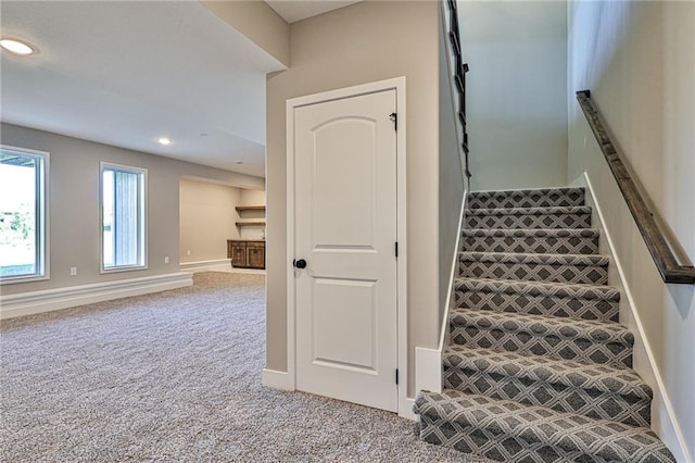 stairway with carpet floors, baseboards, and recessed lighting