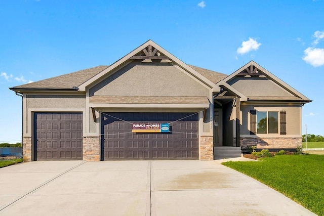 220 SW Chelmsford Dr, Blue Springs, MO 64015 - craftsman-style house featuring stucco siding, an attached garage, stone siding, and concrete driveway