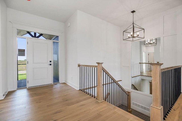 entryway featuring hardwood / wood-style flooring and an inviting chandelier