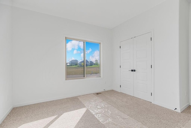 unfurnished bedroom with carpet floors and a closet