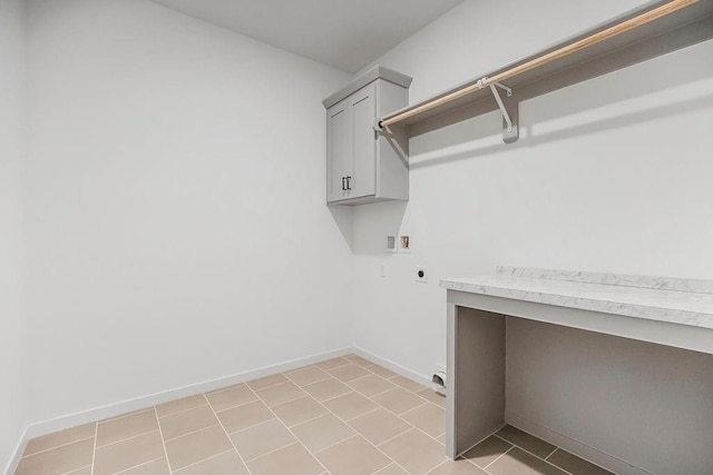 washroom with electric dryer hookup, hookup for a washing machine, light tile patterned flooring, and cabinets