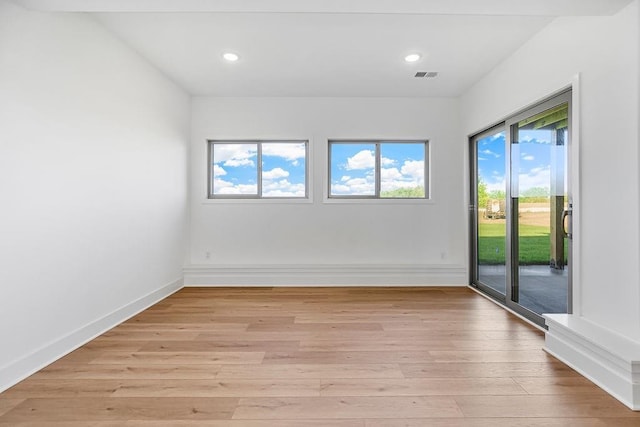 empty room with light hardwood / wood-style flooring