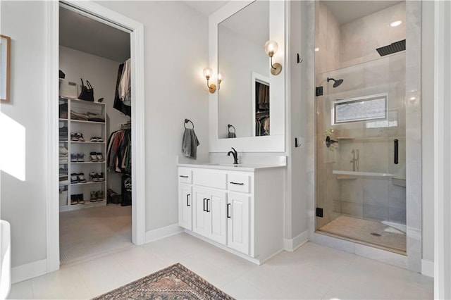 bathroom with an enclosed shower, vanity, and tile patterned flooring