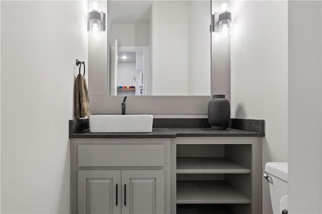 bathroom featuring toilet and vanity