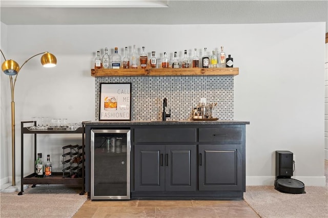 bar featuring light colored carpet, wine cooler, and sink