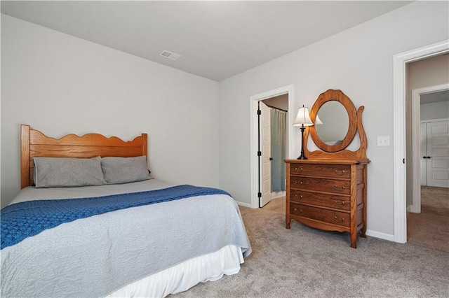 carpeted bedroom featuring ensuite bathroom