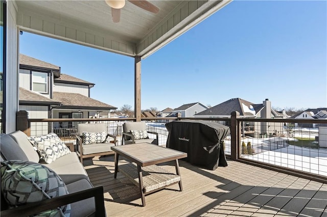 wooden deck with ceiling fan and outdoor lounge area