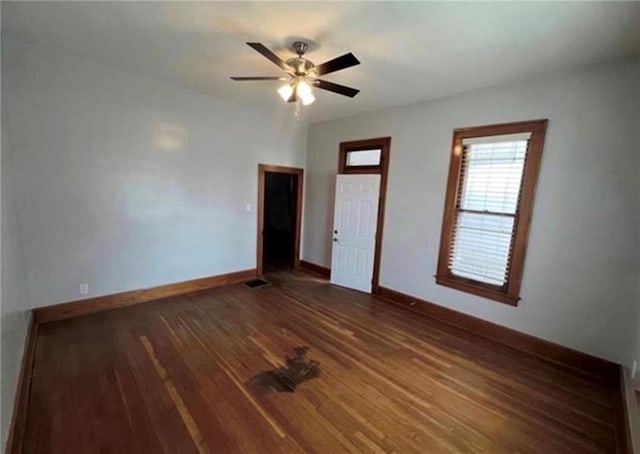 unfurnished room featuring dark hardwood / wood-style floors and ceiling fan