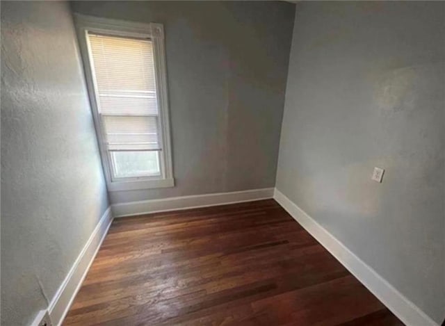 unfurnished room with dark hardwood / wood-style floors