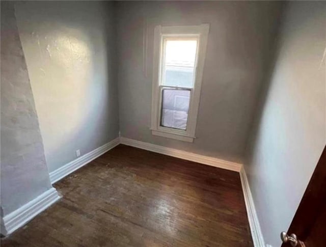 spare room featuring dark hardwood / wood-style floors