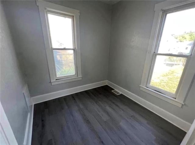 unfurnished room featuring dark wood-type flooring