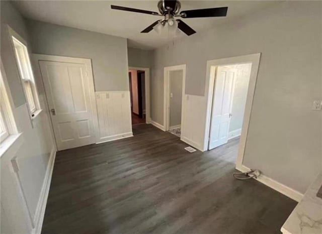 unfurnished room with ceiling fan and dark hardwood / wood-style floors