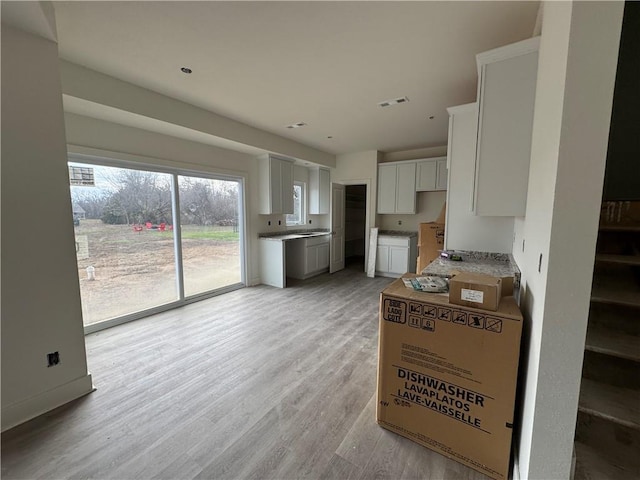 kitchen featuring white cabinetry and light hardwood / wood-style floors