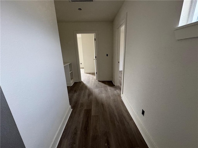 hallway with dark hardwood / wood-style floors