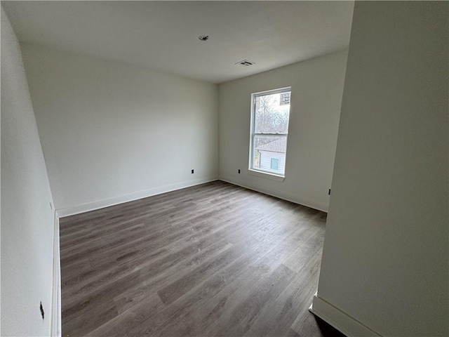 spare room with hardwood / wood-style floors