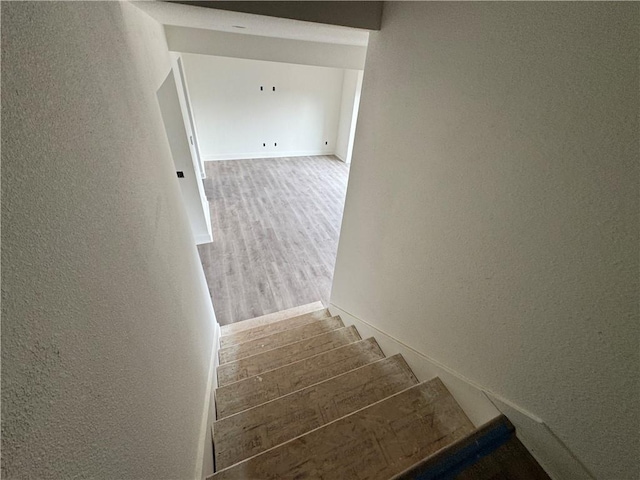 stairs with hardwood / wood-style flooring