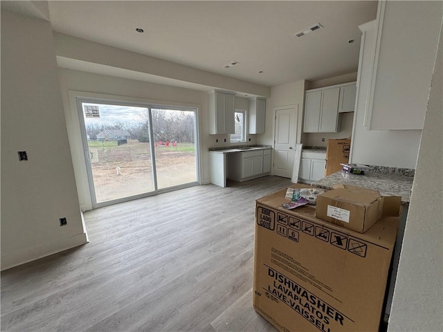 kitchen featuring white cabinets and light hardwood / wood-style floors