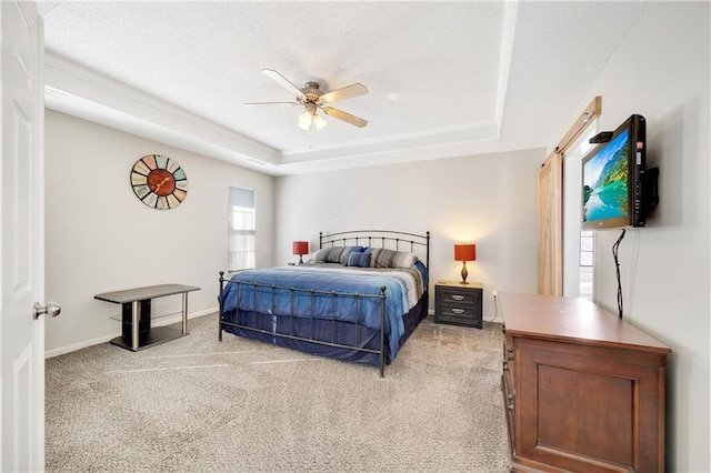 bedroom with ceiling fan, a raised ceiling, and carpet floors