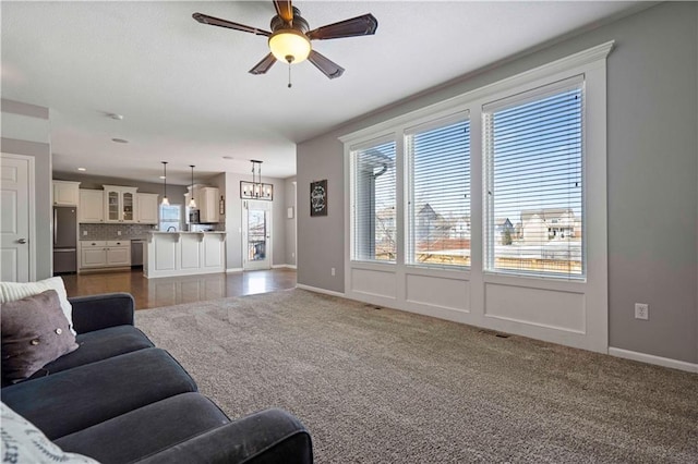 living room with dark colored carpet and ceiling fan