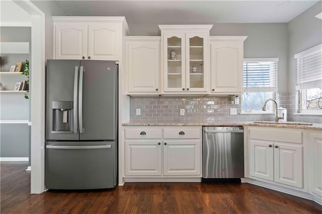 kitchen with sink, white cabinets, and appliances with stainless steel finishes