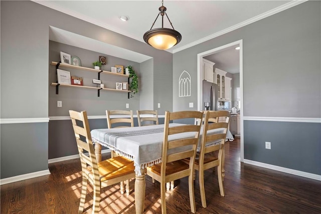 dining space with ornamental molding and dark wood-type flooring