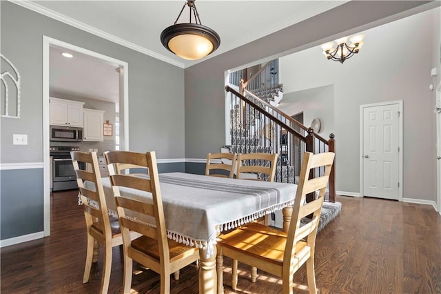 dining room with ornamental molding and dark hardwood / wood-style flooring