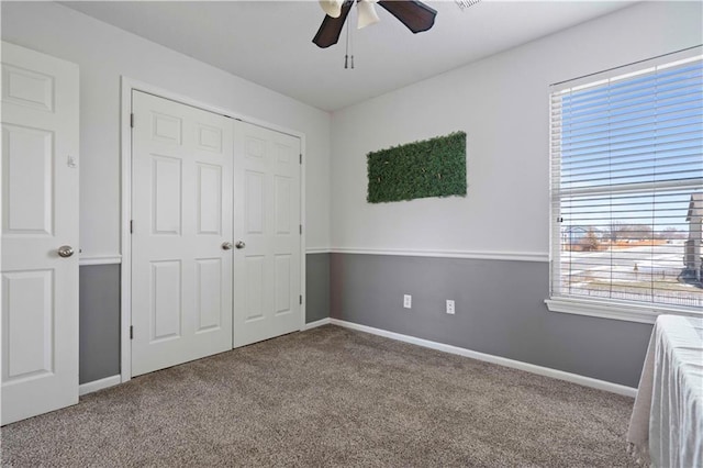 unfurnished bedroom featuring a closet, ceiling fan, and carpet flooring