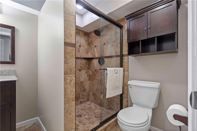 bathroom with vanity, toilet, and walk in shower