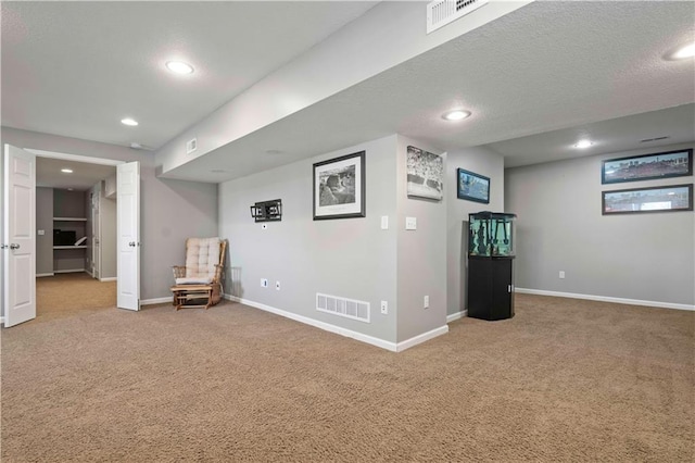 unfurnished room featuring a textured ceiling and carpet