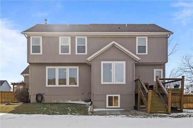 snow covered house featuring a deck