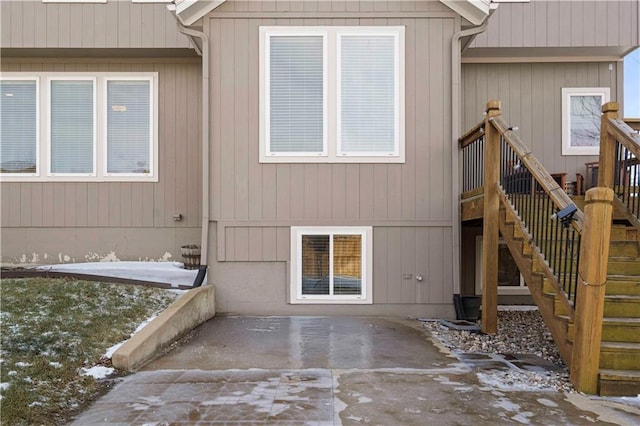 snow covered property with a patio area