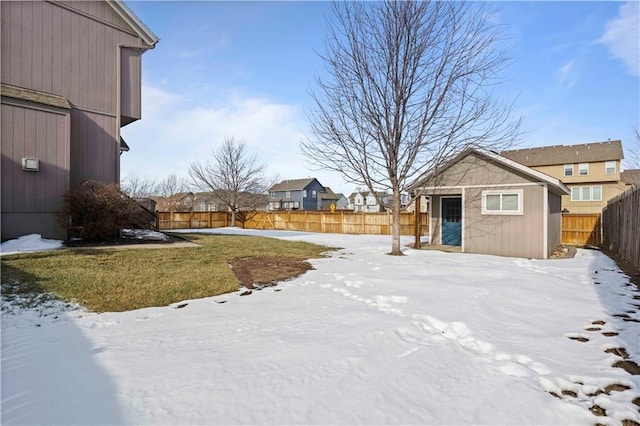 yard covered in snow with an outbuilding