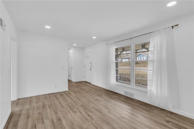 spare room with light hardwood / wood-style flooring