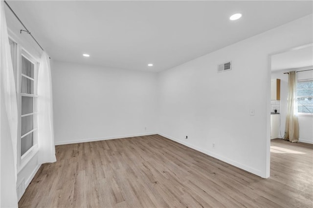 spare room featuring light wood-type flooring