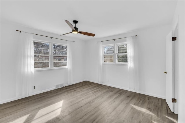 spare room with light hardwood / wood-style floors and ceiling fan