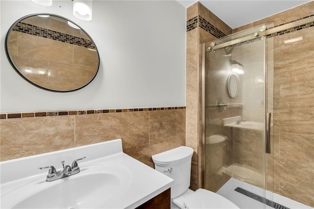 bathroom with vanity, a shower with shower door, and toilet