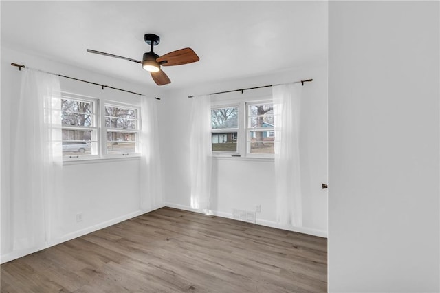 unfurnished room featuring hardwood / wood-style floors and ceiling fan