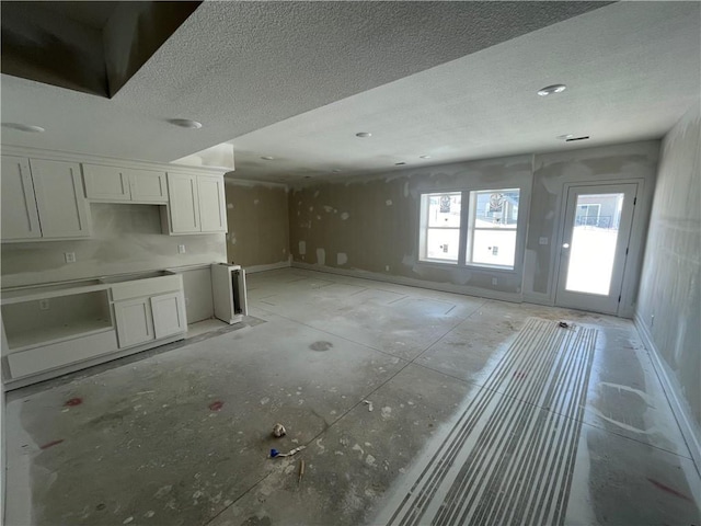 kitchen featuring white cabinetry and a textured ceiling