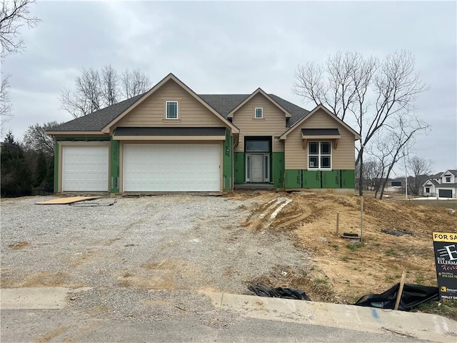 7007 N Kirkwood Ave, Kansas City, MO 64151 - view of front of home featuring gravel driveway and a garage