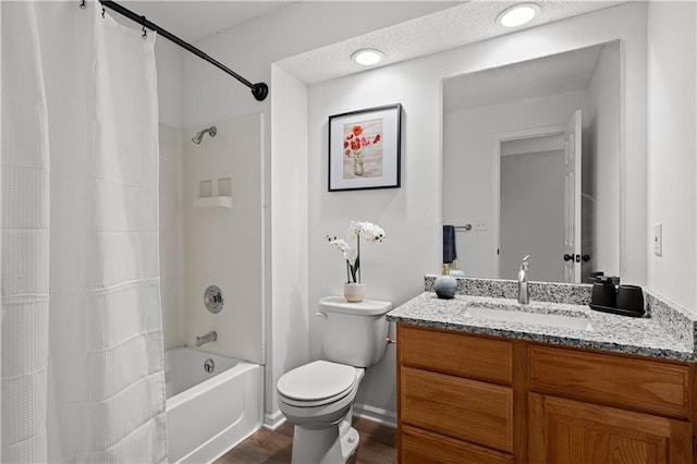 full bathroom featuring hardwood / wood-style floors, a textured ceiling, vanity, shower / bath combination with curtain, and toilet