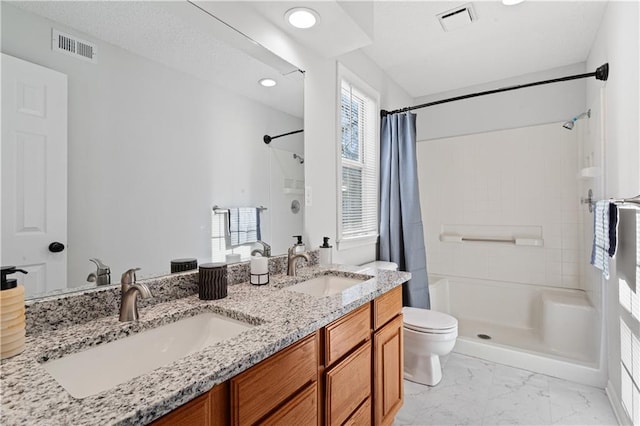 bathroom featuring toilet, vanity, and a shower with shower curtain