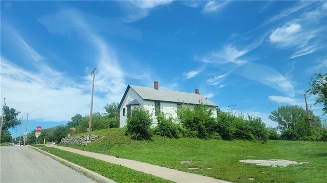 view of side of home with a lawn