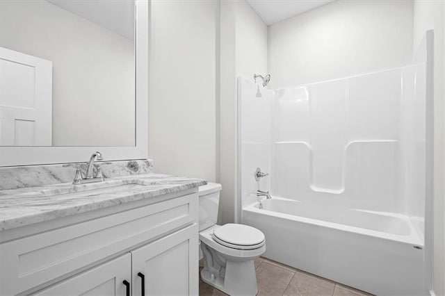 full bathroom featuring toilet, vanity, tile patterned floors, and shower / washtub combination